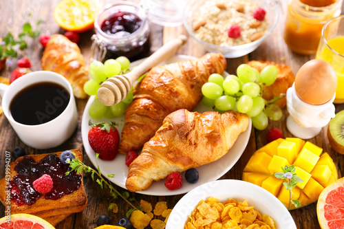 breakfast with coffee cup, croissant and fresh fruits