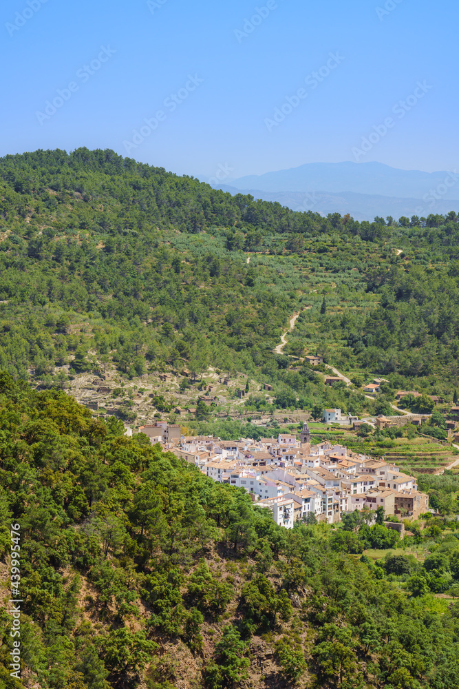 Idyllic white Spanish city in countryside landscape surrounded by a green forest. Aín, Comunidad Valenciana, Spain