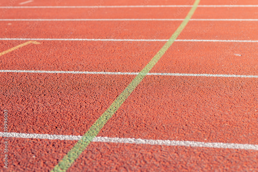 Fototapeta premium Red running track Synthetic rubber on the athletic stadium outdoor.Part shot.