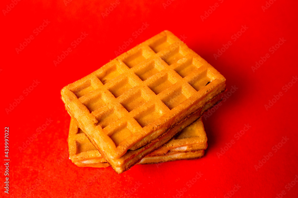 belgian waffles with filling on a red background. belgian waffles with filling on a red background.