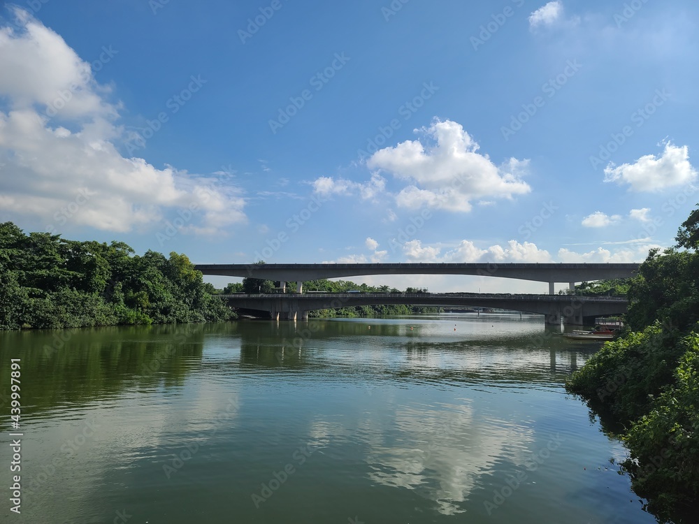 Bridge on reflective river sunny sky, Sengkang Floating Wetland, Singapore Bridge on reflective river sunny sky, Sengkang Floating Wetland, Singapore