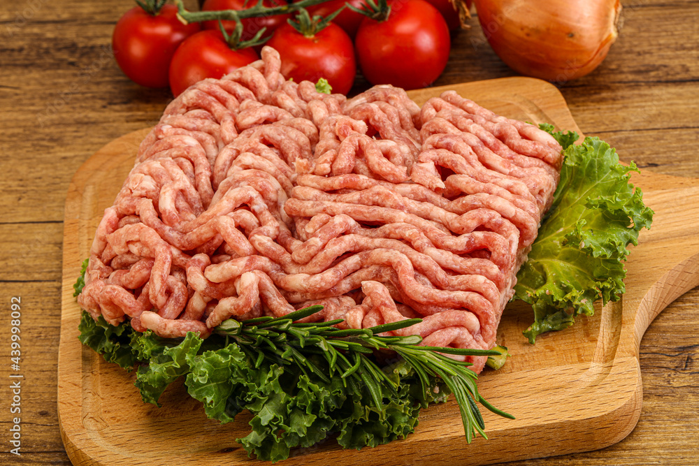 Raw pork minced meat over board Raw pork minced meat over board