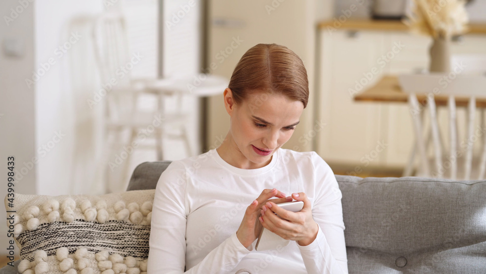 Woman with mobile phone home, beautiful brunette young happy model using smartphone Woman with mobile phone home, beautiful brunette young happy model using smartphone