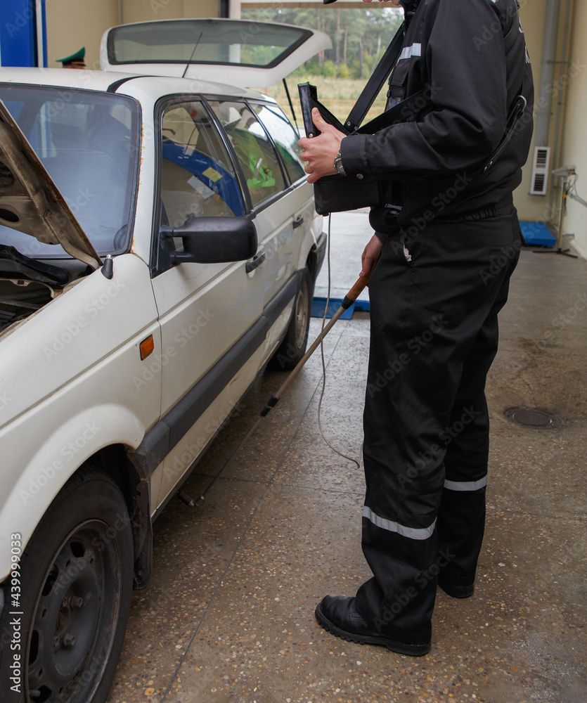 Inspector of the border service searches for contraband Inspector of the border service searches for contraband