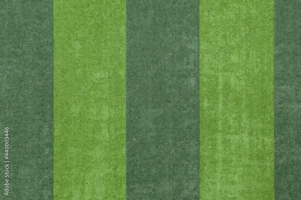 Aerial top view of the green grass texture on the football field