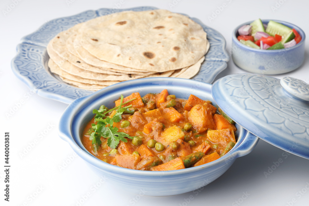 Mix vegetable curry with Naan or Indian bread and raita, Indian meal