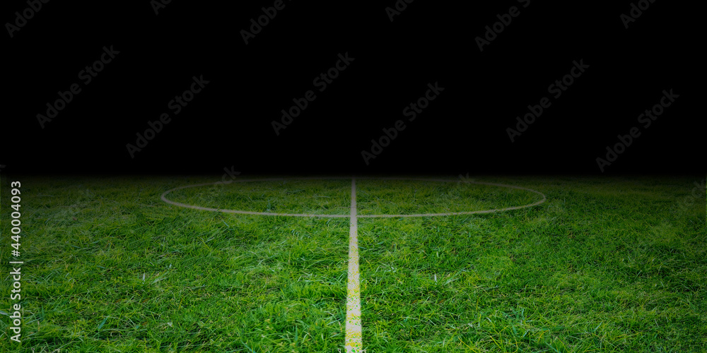 Football field midfield. Soccer stadium from center line. bright green grass at night. empty playground 