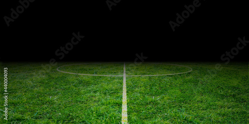 Fototapeta Naklejka Na Ścianę i Meble -  Football field midfield. Soccer stadium from center line. bright green grass at night. empty playground 