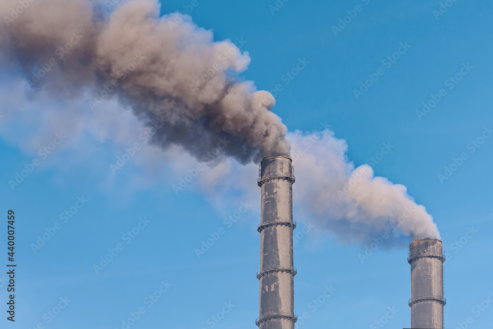 High industrial pipes of thermal power plant. Severe air pollution by smoke (concept of ecology)