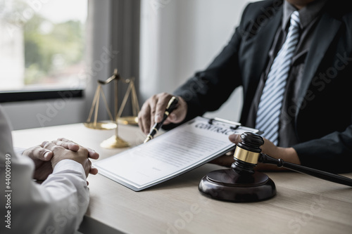 Attorney gives the client a pen to sign a contract admitting fraud, lawyer admits a fraud case in which client is a victim and will sue defendant who is a commercial partner. Fraud litigation concept.