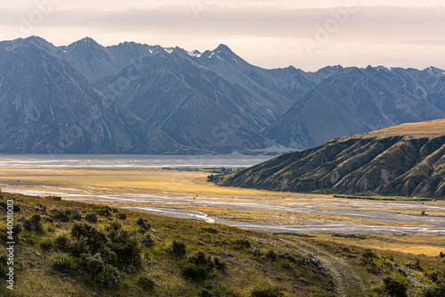 A photo of a confluence of Godley River and Macaulay River feeding Tekapo Lake in New Zealand. Summer time, low water levels, Haszard Ridge in the background