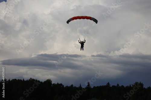 Skydiving. Cloudy sky and a parachute in the sky.