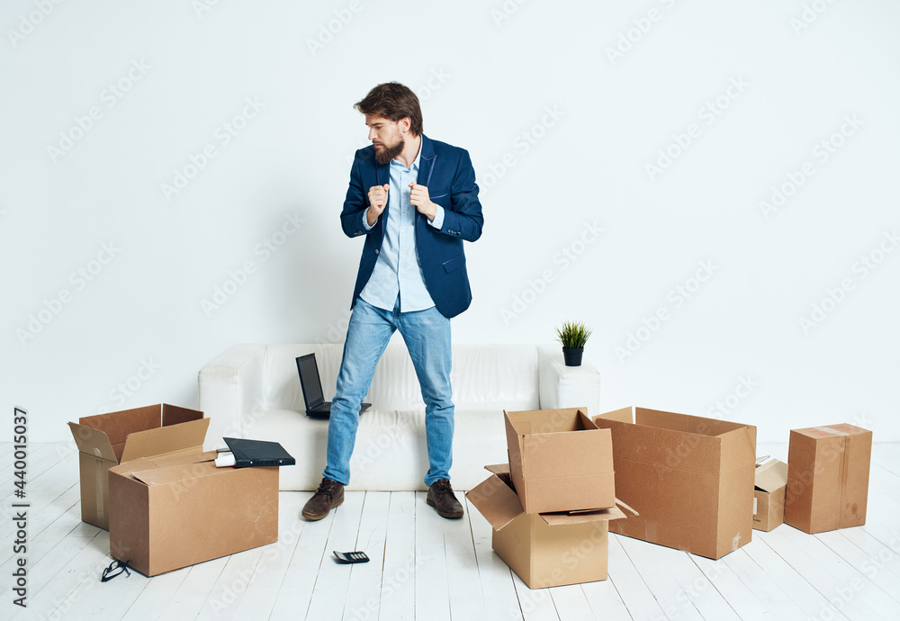 Man sits on the floor with cardboard boxes of things moving work Man sits on the floor with cardboard boxes of things moving work