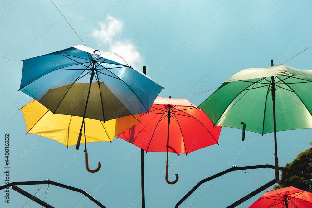 Colorful umbrellas in the sky. Multicolored umbrellas in the sky, creating a summer, art mood on the street