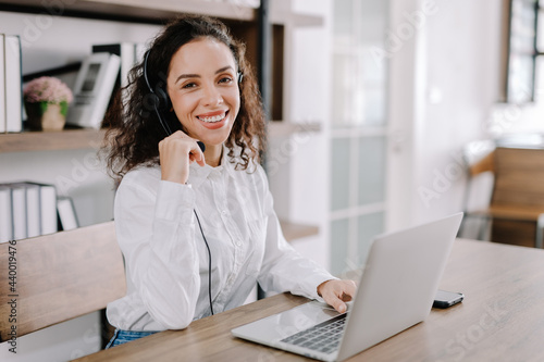 A young businesswoman taking a selfie with her smartphone camera in a happy expression, taking a selfie to show her friends at work, relaxing, and taking a break in the office.