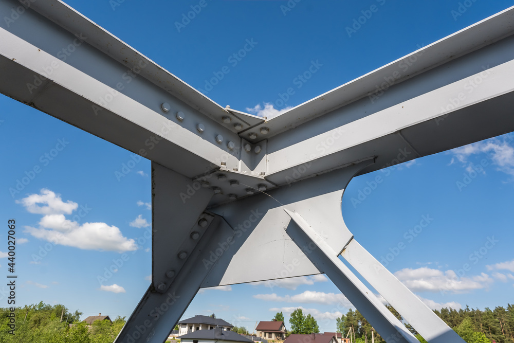 iron steel frame construction of bridge on blue sky background. bridge metal structures, frames, bolts and nuts iron steel frame construction of bridge on blue sky background. bridge metal structures, frames, bolts and nuts