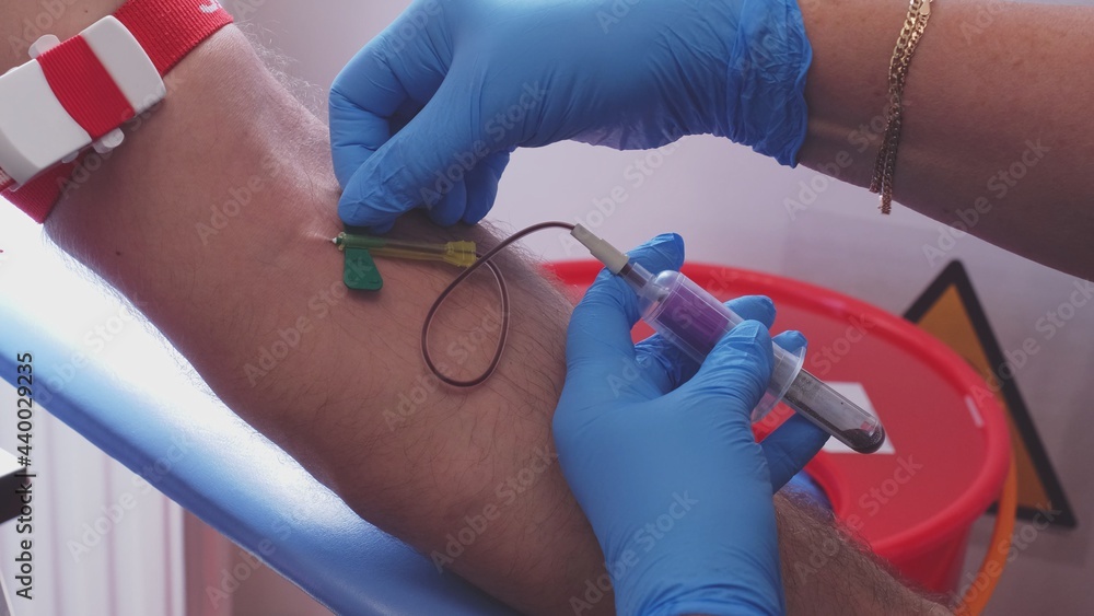 Skilled Professional Nurse in Blue Latex Gloves Collecting Blood Sample