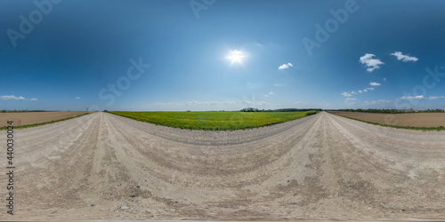 Full spherical seamless hdri panorama 360 degrees angle view on no traffic white sand gravel road with sun on clear blue sky in equirectangular projection, VR AR content