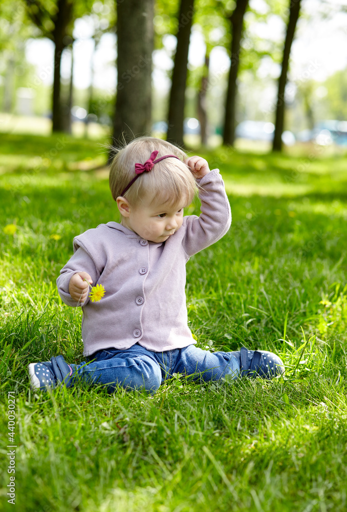 Little girl play in the park and have a good time. The concept of a happy childhood, spring outdoor recreation Little girl play in the park and have a good time. The concept of a happy childhood, spring outdoor recreation