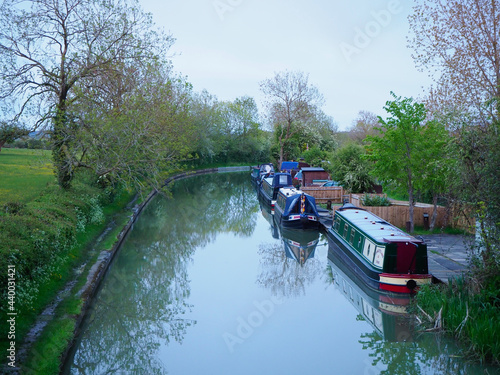 a variety of attractive narrowboats moored along a canal