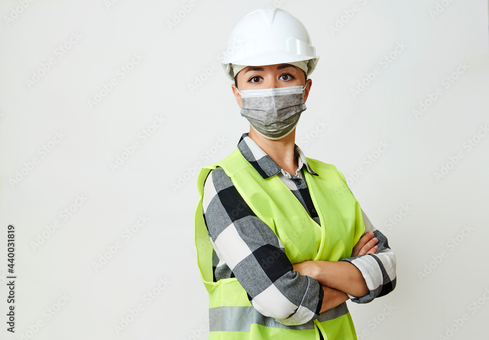 Fototapeta premium Worker woman wearing face mask and protective hard hat.
