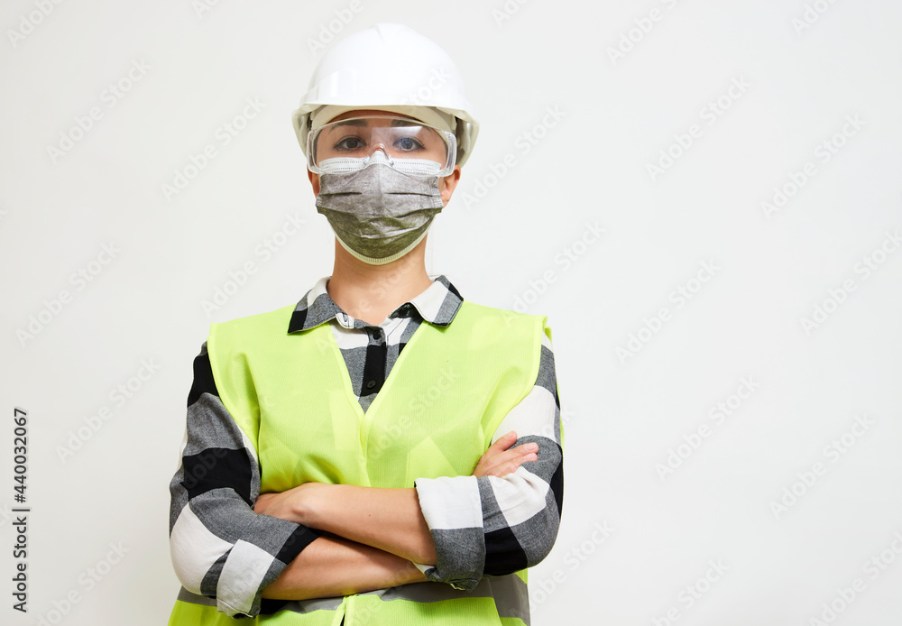 Fototapeta premium Waist up portrait of female builder with hardhat on white background