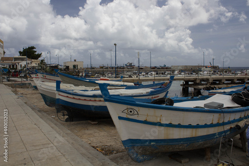 evocative image of fishing boats moored in the harbor in a small fishing village in Sicily  Italy 