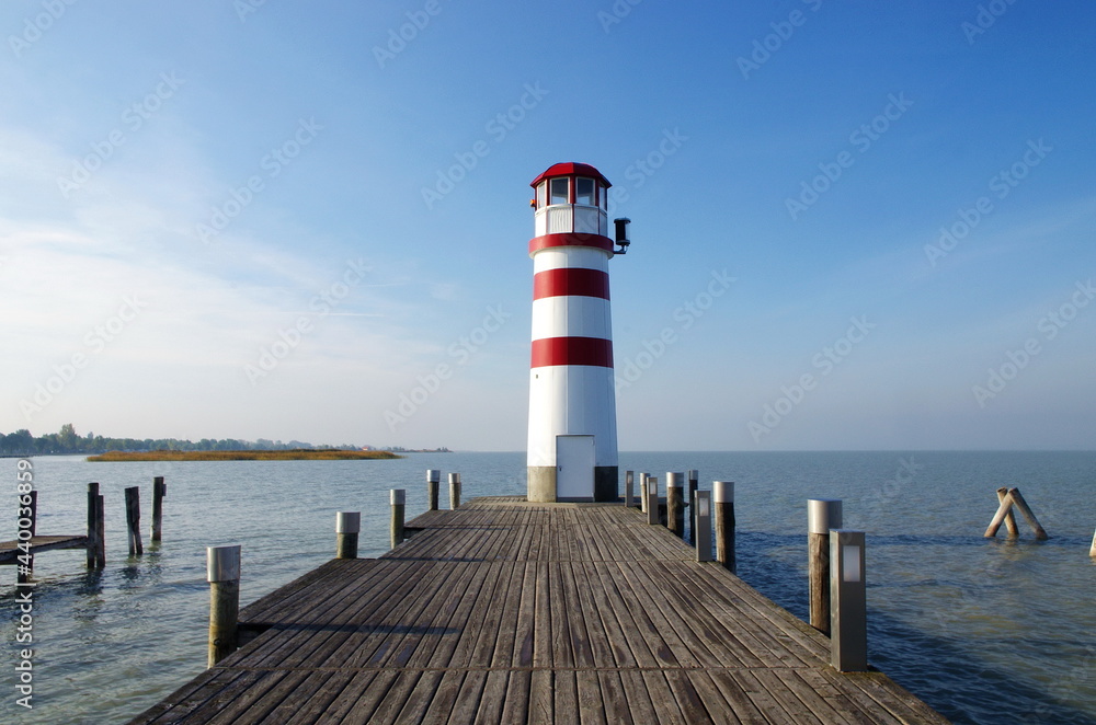 Lighthouse at Lake Neusiedl at beautiful sunny day and blue sky. Wonderful panorama at sea. Neusiedler See, Burgenland, Austria. Beautiful panorama at Lake with lighthouse.