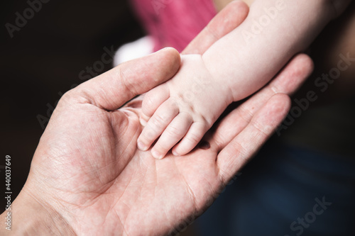 Fototapeta Naklejka Na Ścianę i Meble -  the father holding baby hand