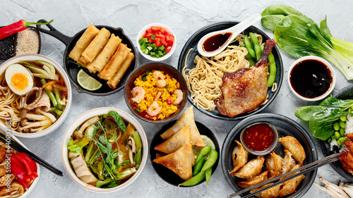 Assorted asian dishes and snacks on dark gray background. Traditional food concept.