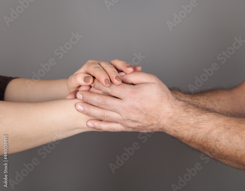 Wallpaper Mural Hands of man and woman holding together, Gray background. Torontodigital.ca