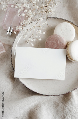 Sheet card mockup , wedding invitation, macaroons, perfume, white flowers on ...