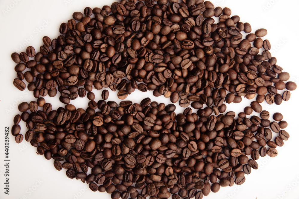Roasted coffee beans laid out in the form of a large coffee grain close-up Roasted coffee beans laid out in the form of a large coffee grain close-up