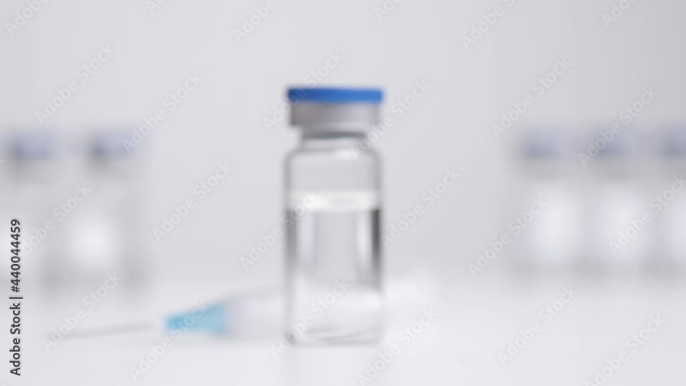 Tracking Shot Approaching Vial of Translucent Liquid and a Syringe Tracking Shot Approaching Vial of Translucent Liquid and a Syringe