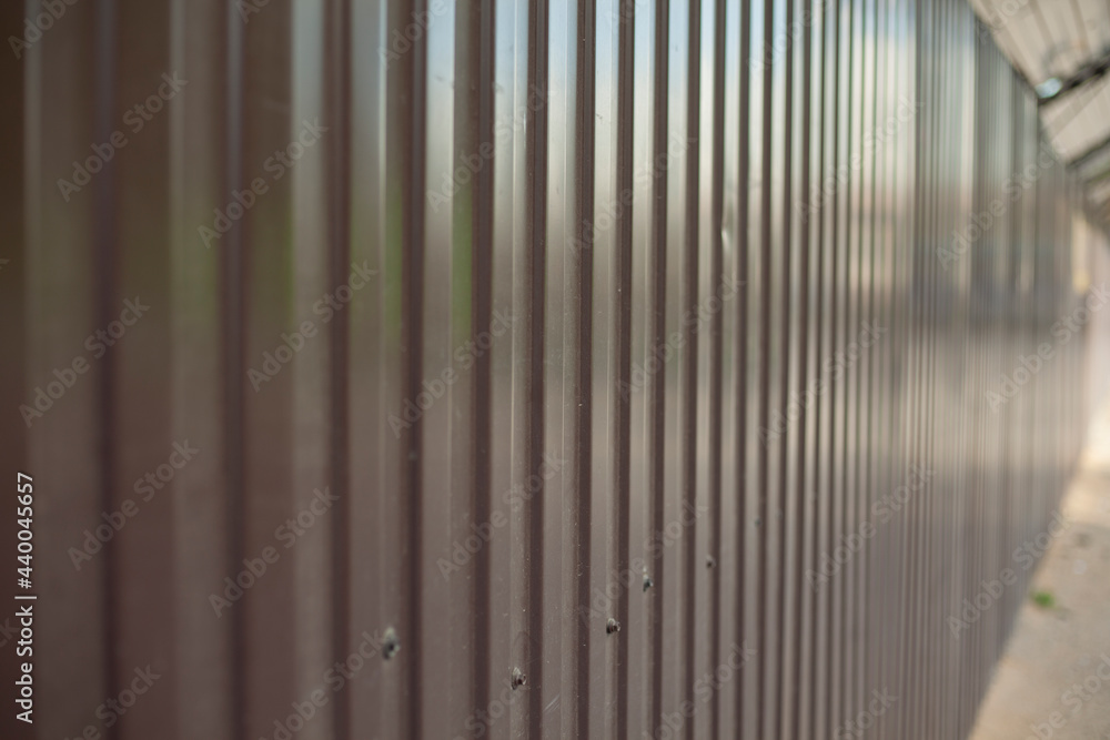 The metal fence is brown. Solid construction site fencing. The metal fence is brown. Solid construction site fencing.