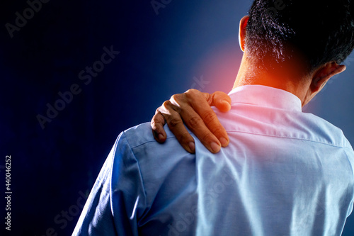 The Asian man in blue got shoulder ache because work from home.