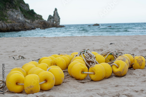 Photography Closeup shot of a yellow buoyancy string on a beach