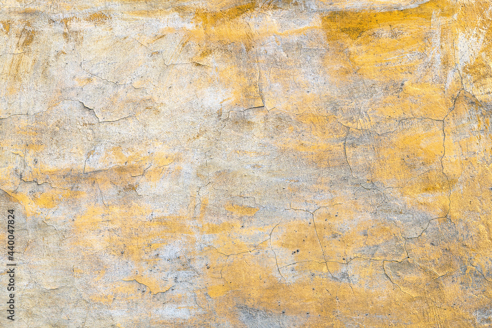 Background with an old concrete wall with an orange cracked paint Background with an old concrete wall with an orange cracked paint