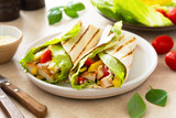 Wrap burrito sandwich or kebab with flatbread with vegetables and white meat.