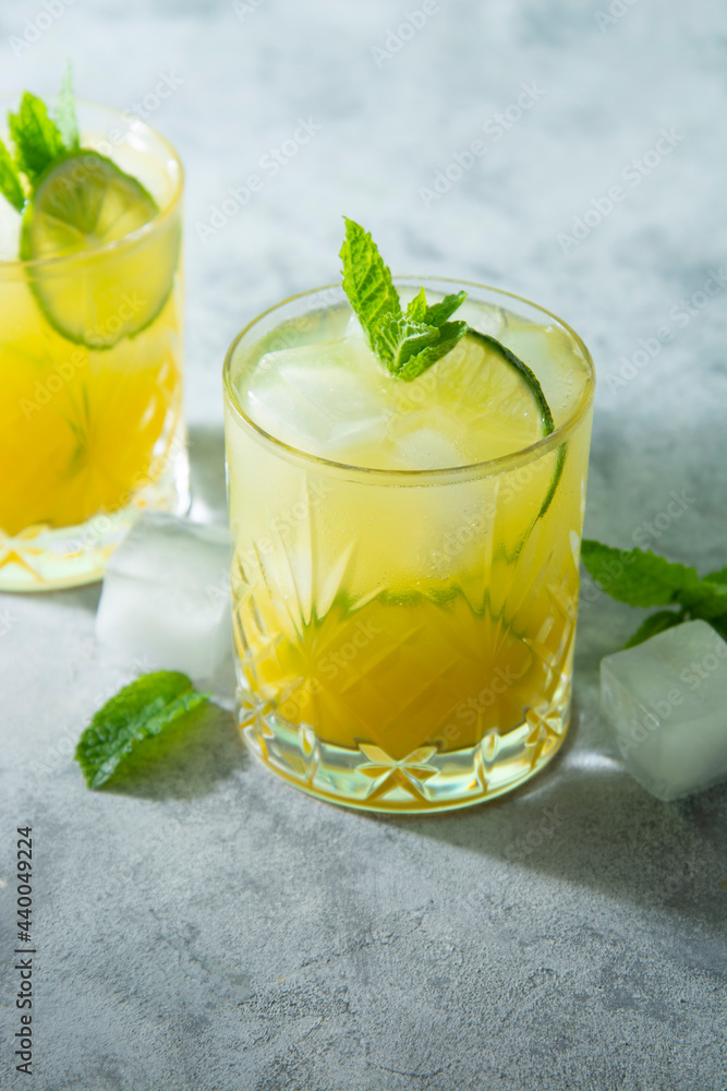 Summer cold drink with ice cubes, juice and lime fruit, summer refreshing drinks. Citrus delicious juice. Summer cold drink with ice cubes, juice and lime fruit, summer refreshing drinks. Citrus delicious juice.
