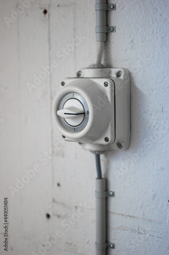 Wall mounted old fashion industrial grade power switch close up shot no people