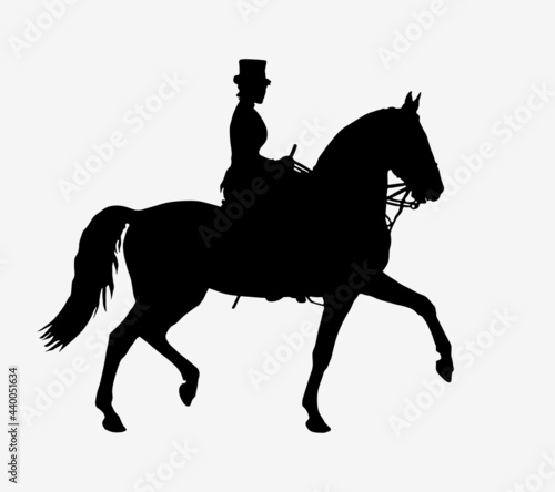 young woman in a woman s saddle riding a black horse