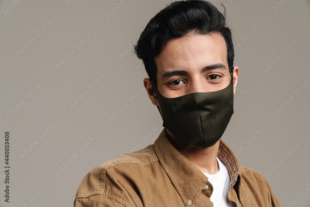 Brunette hispanic man in face mask looking at camera Brunette hispanic man in face mask looking at camera