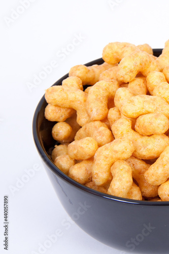 Closeup shot of Peanut flips in the bowl isolated on a white background photo