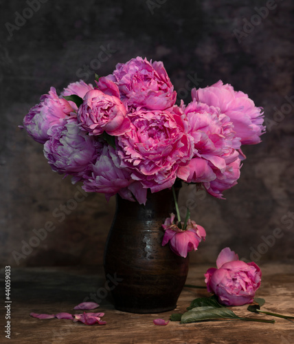 Fototapeta Naklejka Na Ścianę i Meble -  Beautiful bouquet of pink peonies in vase on a wooden table