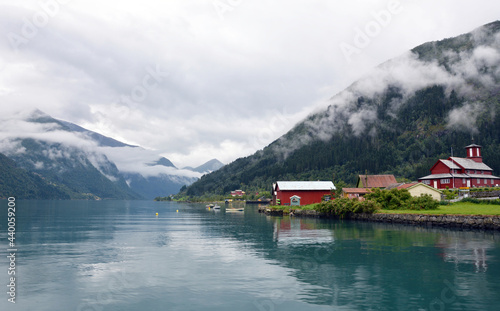 Closeup shot of residential landscape with lake and mountains in Fjaerland in Norway photo