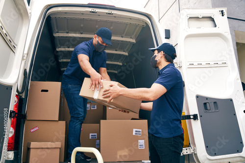 Photography Bottom view of couriers unloading packages during a pandemic