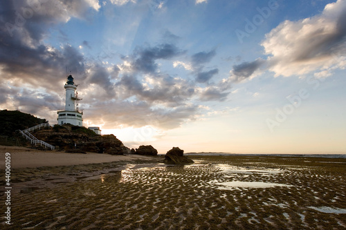 Landscape of lighthouse and beach at low tide photo