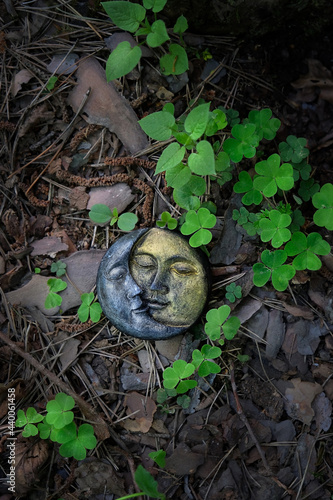 symbolic moon, green clover leaves on natural background. old pagan, Wiccan, Slavic traditions. Witchcraft, esoteric spiritual ritual for equinox. flat lay