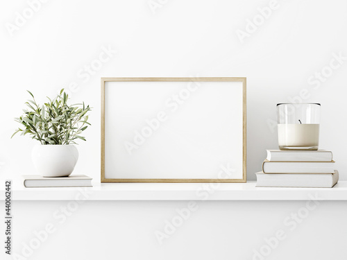 Horizontal wooden frame mockup with green olive twigs in vase and candle on white wall background. A4, A3, A size, 3d rendering, illustration